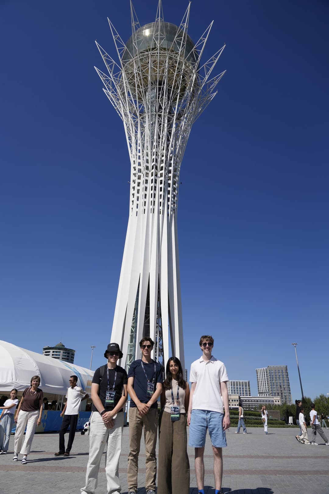 Team Germany standing in front of the Bayterek monument, a white lattice tower topped with a golden sphere