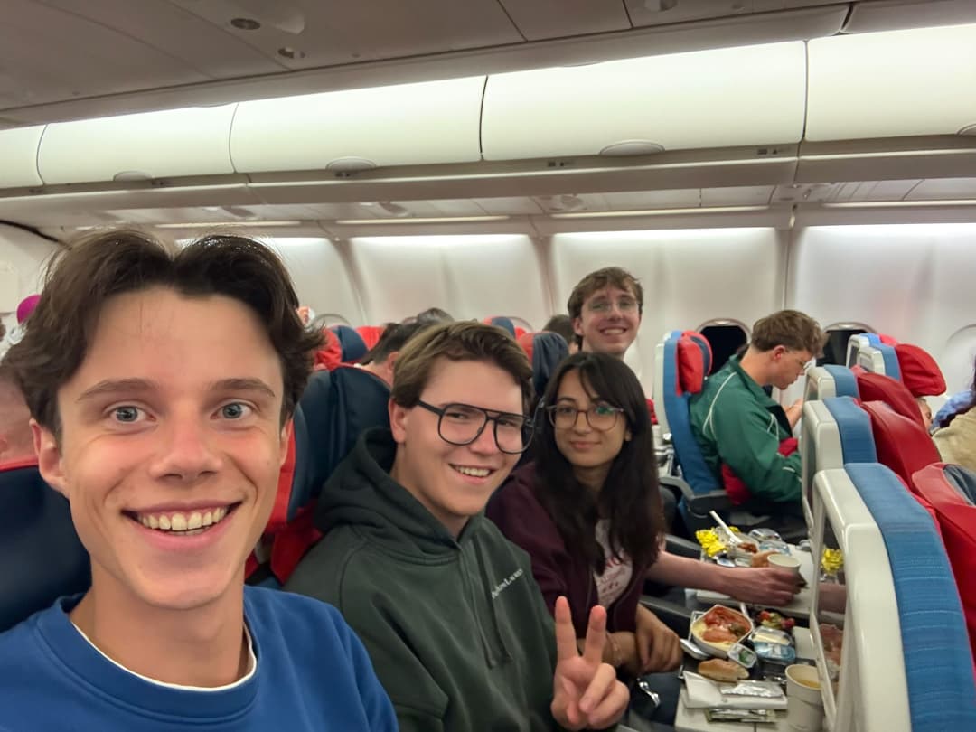 Selfie of Team Germany smiling in their airplane seats during the flight
